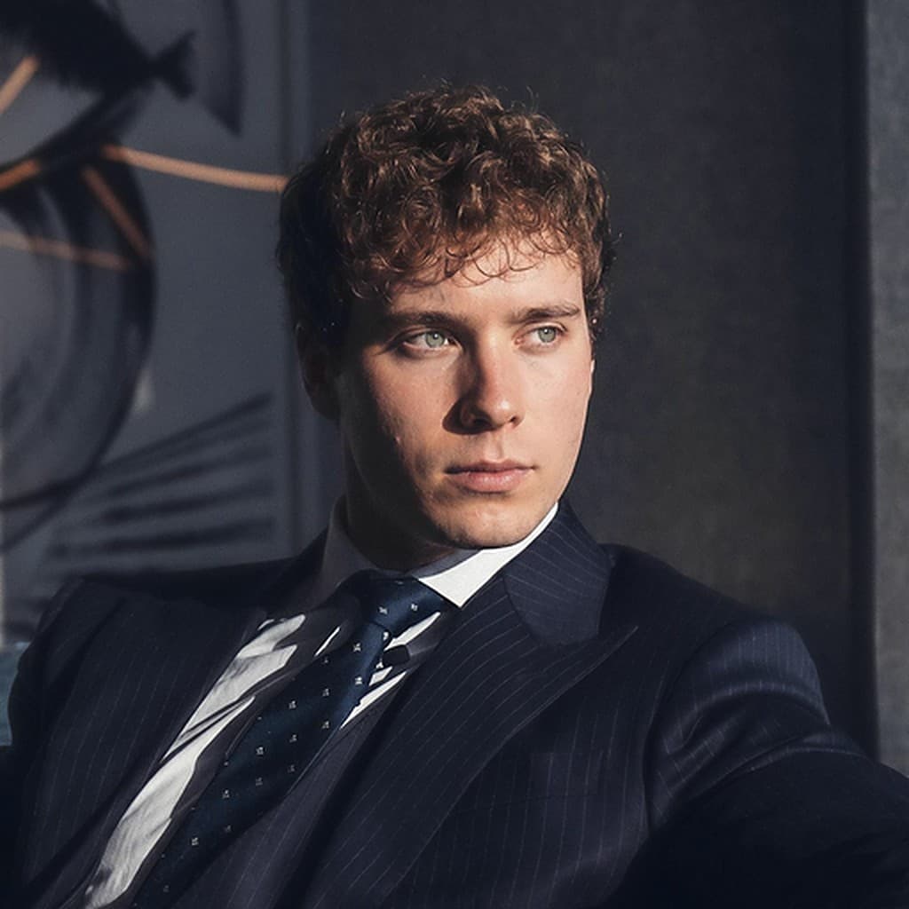 Cameron Sullivan in a pinstripe suit and tie